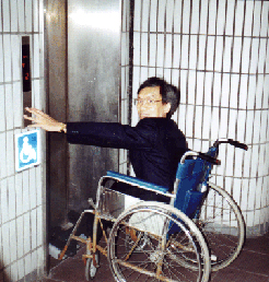 A wheelchair user takes the elevator from the platform level of the Shenzhen, China, railroad station.