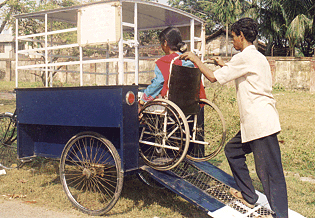 This accessible bicycle rickshaw in India has a rear door which serves as a ramp.<br>Photo courtesy of Bikash Bharati Welfare Society and Lalita Sen.