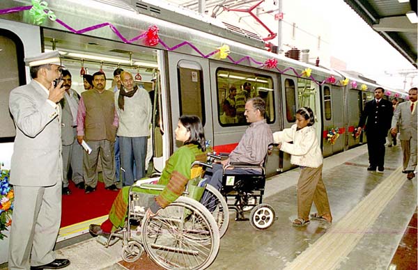 Advocates Anjlee Agarwal (left) and Sanjeev Sachdeva board the accessible Delhi Metro on its inaugural run.<br>Photo courtesy of Sanjay Sakaria and Samarthya, from Amar Ujjala Indian Daily