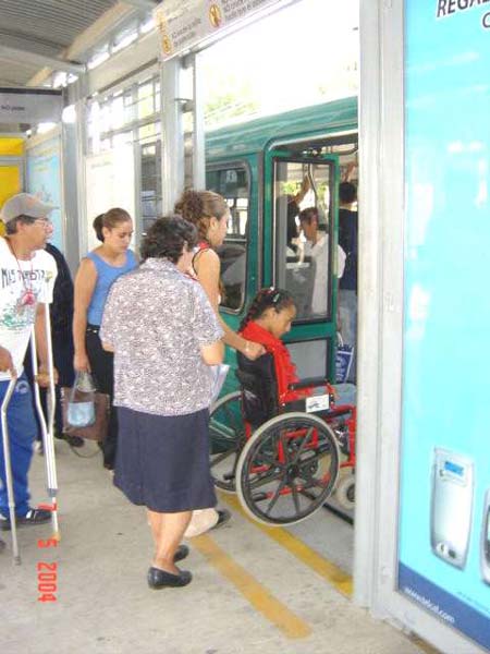 Pre-paid passengers inside a station board a high-capacity BRT bus in León.<br>This and above photo courtesy of Sistema Integrado de Transporte Masivo de León