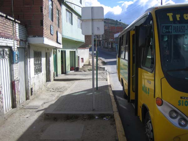 Even when bus stops are not accessible to wheelchair users, access for seniors and others with disabilities can be enhanced by a level all-weather pad even in the absence of paved sidewalks. The photo is from a TransMilenio feeder route in Bogotá.<br>This and above photo by T. Rickert courtesy of World Bank.